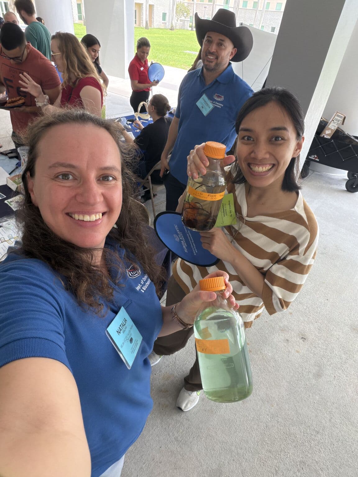 Dr. Natalia Malina and a Transform Lab member holding water samples at the ECOS Kickoff Event at FAU
